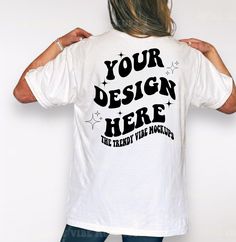 a woman with her back to the camera wearing a t - shirt that says your design here