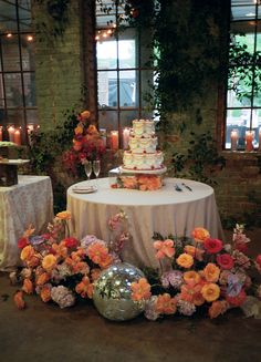 the table is covered with flowers and candles