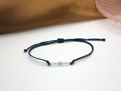 => ᗰᗩTEᖇIᗩᒪS Stainless steel  Swarovski crystals Nylon cord => ᑕOᒪOᑌᖇS Cords: Navy blue Crystals: Clear and Aquamarine Link: Silver => OTᕼEᖇ IᑎᖴOᖇᗰᗩTIOᑎ The bracelet is adjustable. Width: 3 mm Swarovski crystal: 4mm -------------------- 🔥 If you want to stack more bracelets check out the "Braided bracelets" section in my shop for more designs:  https://etsy.me/3zVRYyJ -------------------- => SᕼIᑭᑭIᑎG All orders are packed with care. You will receive a tracking code when your item is shipped. => Cord Jewelry, Swarovski Bracelet, Macrame Cord, Braided Bracelets, Crystal Bracelet, Blue Crystals, Crystal Bracelets, Clear Crystal, Arm Band