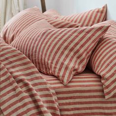 a bed with red and white striped sheets