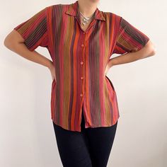 Striking vertical stripe ladies shirt in crinkle viscose. It has a straight, relaxed, elongated shape with short sleeves, side slits and a v-neck or a closed straight collar. Beautiful autumnal, earthy colours. Made in the U.K. by St.Michael, M&S. 100% viscose. Medium size, labelled as 12UK, 40EUR. Measurements when laid flat are: Pit to pit: 55cm Waist: 54cm Length: 69cm Great overall condition, but has a couple of horizontally pulled threads along the bottom three button lines. Casual Collared Blouse With Vertical Stripes, Striped Relaxed Fit Short Sleeve Blouse, Striped Short Sleeve Blouse With Relaxed Fit, Multicolor Short Sleeve Shirt With Vertical Stripes, Earthy Colours, Ladies Shirt, Sequin Jacket, Earthy Colors, Womens Blouses