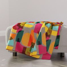 a couch with a colorful blanket on top of it