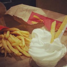 french fries and whipped cream in a paper bag