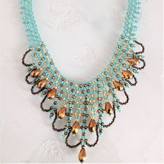 the necklace is adorned with blue beads and gold accents