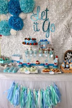 a dessert table with blue and white decorations