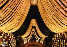 the entrance to an event decorated in gold and white