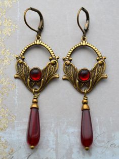 Ornate Red Teardrop Jewelry, Vintage Bronze Brass Earrings, Vintage Red Copper Jewelry, Vintage Metal Earrings For Festive Occasion, Red Vintage Copper Jewelry, Vintage Antique Gold Earrings With Intricate Design, Bronze Brass Earrings For Vintage Collection, Festive Vintage Brass Earrings, Vintage Antique Gold Copper Earrings