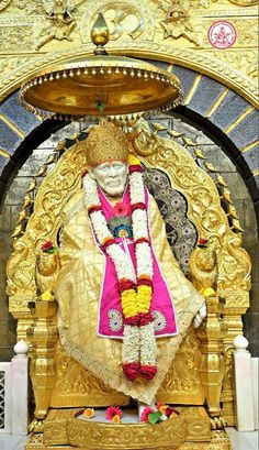 the statue is decorated in gold and pink