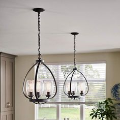 three lights hanging from the ceiling in a kitchen