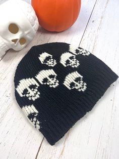 Black Skull Mens Beanie Cap Hand knitted Wool Cap with Skull  Unisex design, handmade  Perfect beanie for this Winter. Made with 100%  New Zealand  wool, lined with soft fleece.  Unique gift for your loved ones who are into gothic style.  Warm cap to wear every day or for hiking, running, skiing, or any outdoor activities.  Hand wash separately in cold water, flat dry. Stretches to fit into comfortable size. Approximate measurements:  Height-9" Width-10"  Black and Ivory color combination with s Black Skull Hat For Halloween, Black Knitted Hat For Halloween, Halloween Beanie One Size Fits Most, Black Skull Print Hat, Black Novelty Beanie, Black Novelty Beanie For Winter, Black Novelty Beanie One Size Fits Most, Halloween One Size Beanie Cap, Novelty Black Beanie, One Size Fits Most