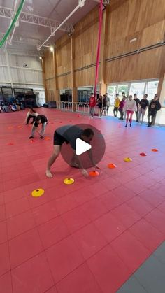 people are doing tricks on the floor in an indoor area with red tiles and yellow circles