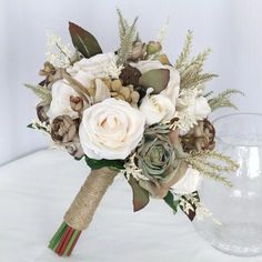 a bridal bouquet with white roses and greenery