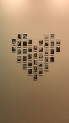 a wall with many pictures hanging on it