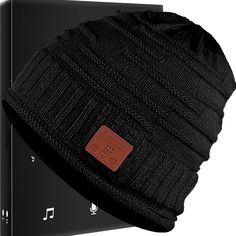 a black beanie hat sitting on top of an electronic device box with music notes attached to it