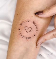 a woman's arm with a tattoo that says i love you and heart shaped