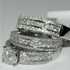 a couple of wedding rings sitting on top of each other