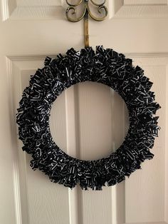 a black wreath hanging on the front door