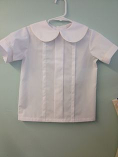 Basic boys suit with no frills. Piped collar and sleeves color of shorts. Button on or banded over shirt. Classic School Tops, Classic Collared Tops For School, Classic White Collared Sets, Classic Summer School Tops, Classic Fitted Shirt For School, Classic Button-up Tops For School, Classic Short Sleeve School Shirt, Classic Short Sleeve Shirt For School, Classic School Shirt With Button Closure