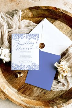 a blue and white wedding suite on a wooden plate