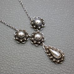 A dainty vintage 835 silver filigree collier necklace. The central part of this bib necklace is featuring 4 handcrafted Dutch buttons, which are also known as "Zeeuwse Knoop". The Zeeuwse Knoop is a symbol of the Zeeland province in the Netherlands and is highly valued for its beauty and historical significance. This vintage Dutch button 835 silver filigree necklace is an authentic handcrafted piece of mid century jewelry, with lots of character. The necklace will be shipped in a gift box. Neckl Victorian Style Silver Necklaces With Vintage Charm, Vintage Silver Necklaces With Vintage Charm, Vintage Silver Necklace With Vintage Charm, Classic Silver Necklace With Vintage Charm, Silver Classic Necklace With Vintage Charm, Silver Necklace With Vintage Charm, Victorian Sterling Silver Nickel-free Necklace, Nickel-free Victorian Sterling Silver Necklaces, Nickel-free Victorian Sterling Silver Necklace