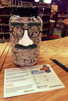 a paper mache with glasses and a fake mustache is on a table next to a pencil