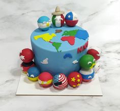 a birthday cake decorated with different types of toys on top of a marble countertop