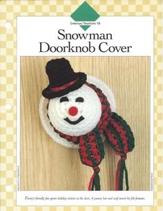 a crocheted snowman doorknob cover