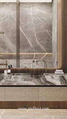 a bathroom with marble counter tops and large mirrors