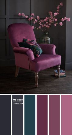 a purple chair and some pink flowers in a room with dark walls, wood floors and flooring