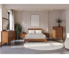 a bed room with a neatly made bed and two dressers next to each other