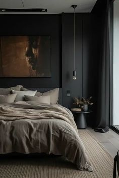 a bedroom with black walls and neutral bedding