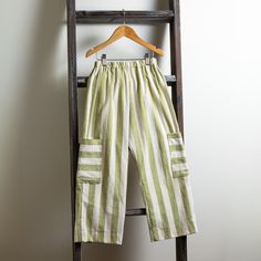 a pair of striped pants hanging on a ladder