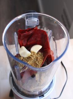 a blender filled with food on top of a wooden table