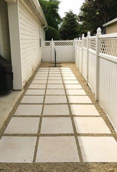 a white picket fence next to a house