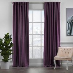 a chair sitting in front of a window with purple curtains