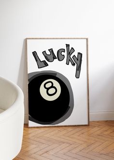 a black and white poster with the word lucky on it next to a pool ball