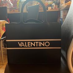 You Can't Go Wrong With The Meline Tote From Valentino By Mario Valentino. This Leather Handbag Features An Embossed Logo Accent And Removable Crossbody Strap For Carrying Versatility. Leather Color: Black Top Snap Closure Top Handles With 6" Drop Removable Shoulder Strap With 17" Max. Drop Interior Pockets: 1 Pen Holder, 1 Zip, 3 Slip Leather Lining 12" L X 6" W X 9" H Made In Italy New, Not Used With Duster Bag And Card Included. Leather Bags With Designer Logo For Shopping, Designer Logo Leather Bags For Shopping, Black Designer Logo Bag For Everyday, Black Designer Logo Bag For Everyday Use, Designer Logo Leather Shopping Bags, Black Designer Logo Rectangular Bag, Black Rectangular Bag With Designer Logo, Black Rectangular Designer Logo Bag, Designer Logo Bags For Shopping