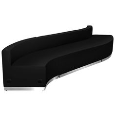 a black couch sitting on top of a white floor