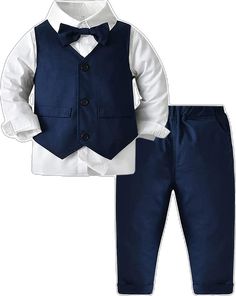 a little boy wearing a blue suit and bow tie with white shirt, pants and shoes