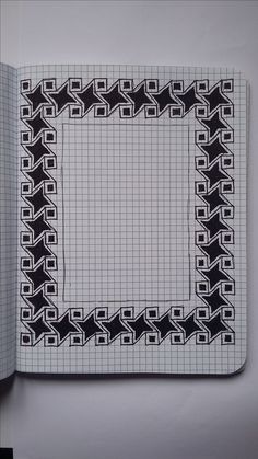 an open notebook with black and white designs on it