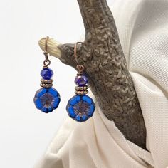 Stunning Cobalt Blue Czech Glass Flower Earrings with Cobalt Blue Fire-polished Crystal Bead. Small, 1-1/4 x 1/2 inch floral earrings. Handmade with Czech glass beads and copper accent beads. Copper wire and ear wires. Lead and nickel free. Very pretty earrings, if you love the cobalt or sapphire blue color, you will love these earrings! The copper accent beads highlight the copper Picasso wash and the copper etching on the flower bead. Each pair of my earrings comes with a soft, flexible clear Blue Flower Earrings With Ear Wire For Party, Blue Bohemian Flower Earrings For Party, Blue Teardrop Flower Earrings Nickel Free, Blue Teardrop Nickel Free Flower Earrings, Blue Teardrop Nickel-free Flower Earrings, Adjustable Blue Flower Earrings With Czech Glass, Blue Beaded Flower Earrings, Blue Beaded Adjustable Flower Earrings, Adjustable Nickel-free Blue Flower Earrings