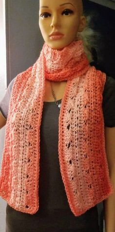 a mannequin wearing an orange knitted scarf