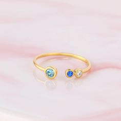 "♥ Custom Birthstone Ring ♥ Customed by kids' birthstones, this beautiful and dainty ring is a perfect gift for your mom or your loved one. P R O D U C T ∙ I N F O * Material: Solid 925 Sterling Silver * Finishing: Silver - Yellow Gold - Rose Gold * Up to 1 big stone, 5 small stones * Big stone measures approx. 1/8'' (3mm) , Small stones measure approx. 1/16'' (2mm) H O W * T O * O R D E R 1. Select the drop-down option you want 2. Please let us know the following information in the \"Add your p Adjustable Birthstone Ring For Birthday, Adjustable Bezel Setting Birthstone Ring As Gift, Adjustable Bezel Set Birthstone Ring Gift, Personalized Birthstone Ring For Birthday Gift, Adjustable Dainty Birthstone Ring As Gift, Birthday Birthstone Ring With Gemstone, Round Birthstone Ring For Birthday Gift, Open Ring Birthstone With Bezel Setting For Gift, Round Birthstone Ring As Birthday Gift