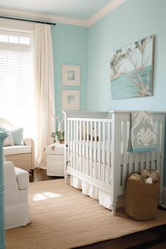 a baby's room with a white crib, blue walls and beige carpet