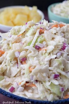 a bowl filled with coleslaw next to bowls of potato chips