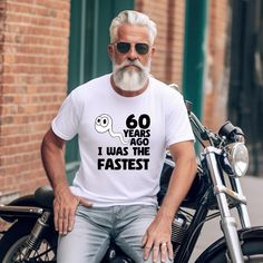 Make his 60th a laugh riot with this Funny 60th Birthday T-Shirt! This hilarious tee is the perfect gift for Dad, your husband, or any guy turning the big 6-0. It celebrates his milestone birthday with humor and lets him show off (or hide?) his age in style. The unisex soft-style t-shirt puts a new spin on casual comfort. Made from very soft materials, this tee is 100% cotton for solid colors. Heather colors and sports grey include polyester. The shoulders have twill tape for improved durability Bday Shirt, Men Tshirt, 60th Birthday Gifts, Tshirt Funny, Milestone Birthday, Gift For Husband, Mens Birthday Gifts, T Shirts With Sayings, 60th Birthday