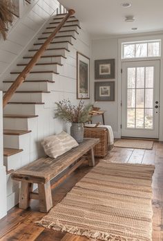 a wooden bench sitting under a stair case