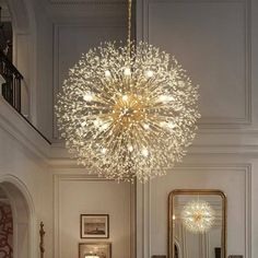 a large chandelier hanging from the ceiling in a room with white walls and flooring