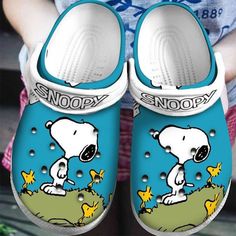 Snoopy Flower &amp Grass Pattern Crocs Classic Clogs Shoes In Blue &amp White  Clog Shoes is a iconic shoes are designed with a unique blend of functionality and fashion. Made from a lightweight and durable material called Croslite, Clog provide cushioning and support for all-day wear. Whether you’re strolling on the beach, running errands, or lounging at home, Clogs are the perfect companion. With a wide range of vibrant colors and trendy patterns, there’s a pair of Clogs to sui... Cute Crocs Shoes, Crocs Shoes Women, Snoopy Stuff, Crocs Slippers, White Clogs, Crocband Clog, Beach Running, Iconic Shoes