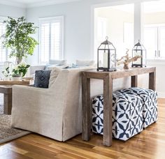 a living room filled with furniture and a wooden table in the middle of the room